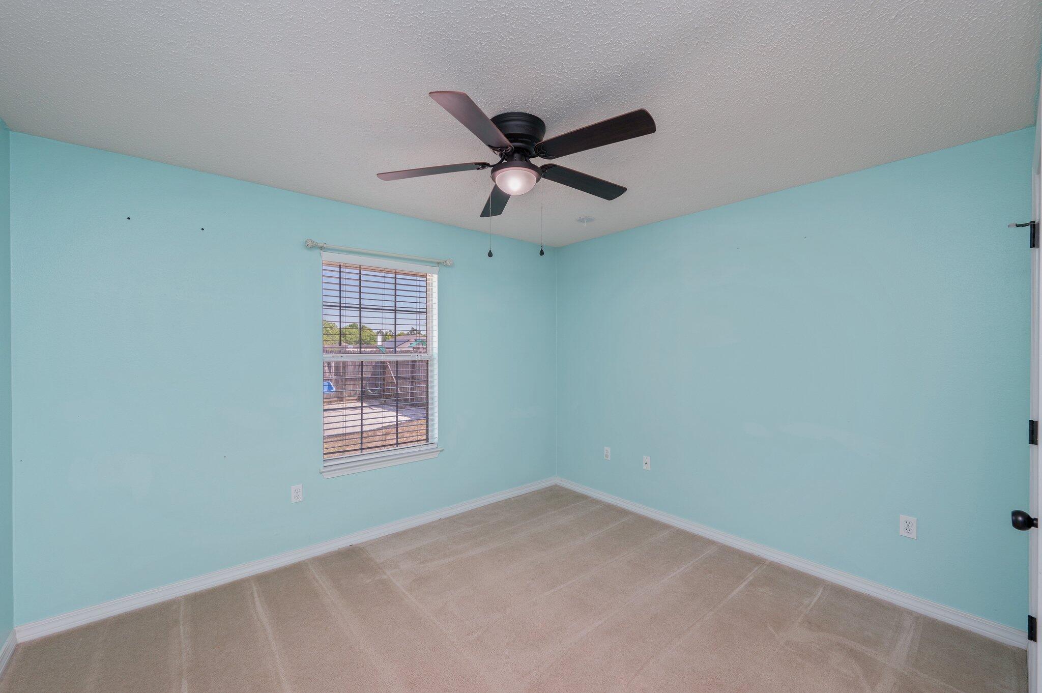 208 Citadel Lane Crestview, FL 32539 - Photo 14 of 27 a view of a big room with windows and ceiling fan