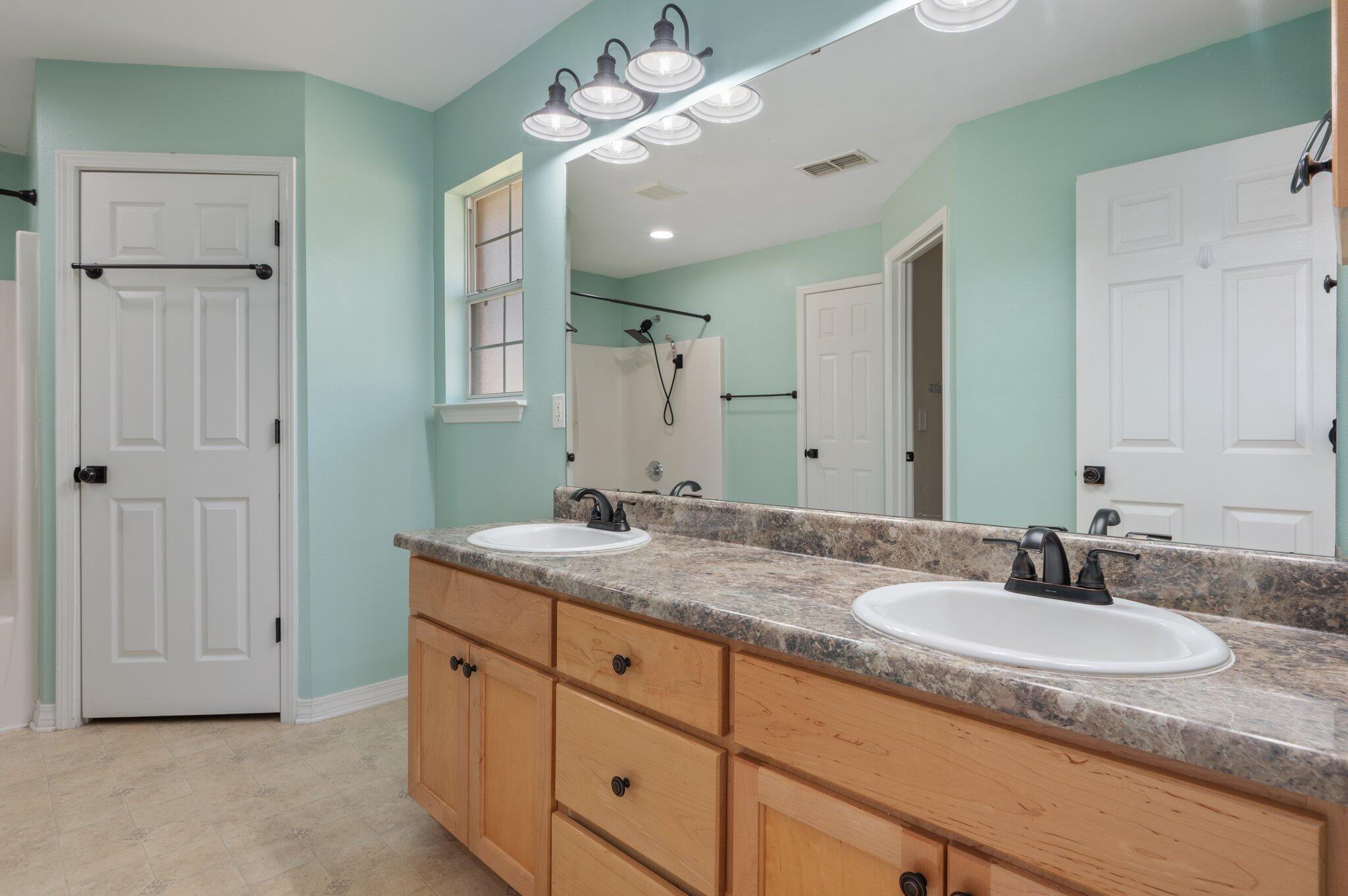 208 Citadel Lane Crestview, FL 32539 - Photo 24 of 27 a bathroom with a granite countertop double vanity sink and a mirror