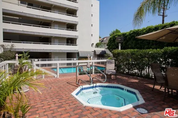 a view of a swimming pool with a patio