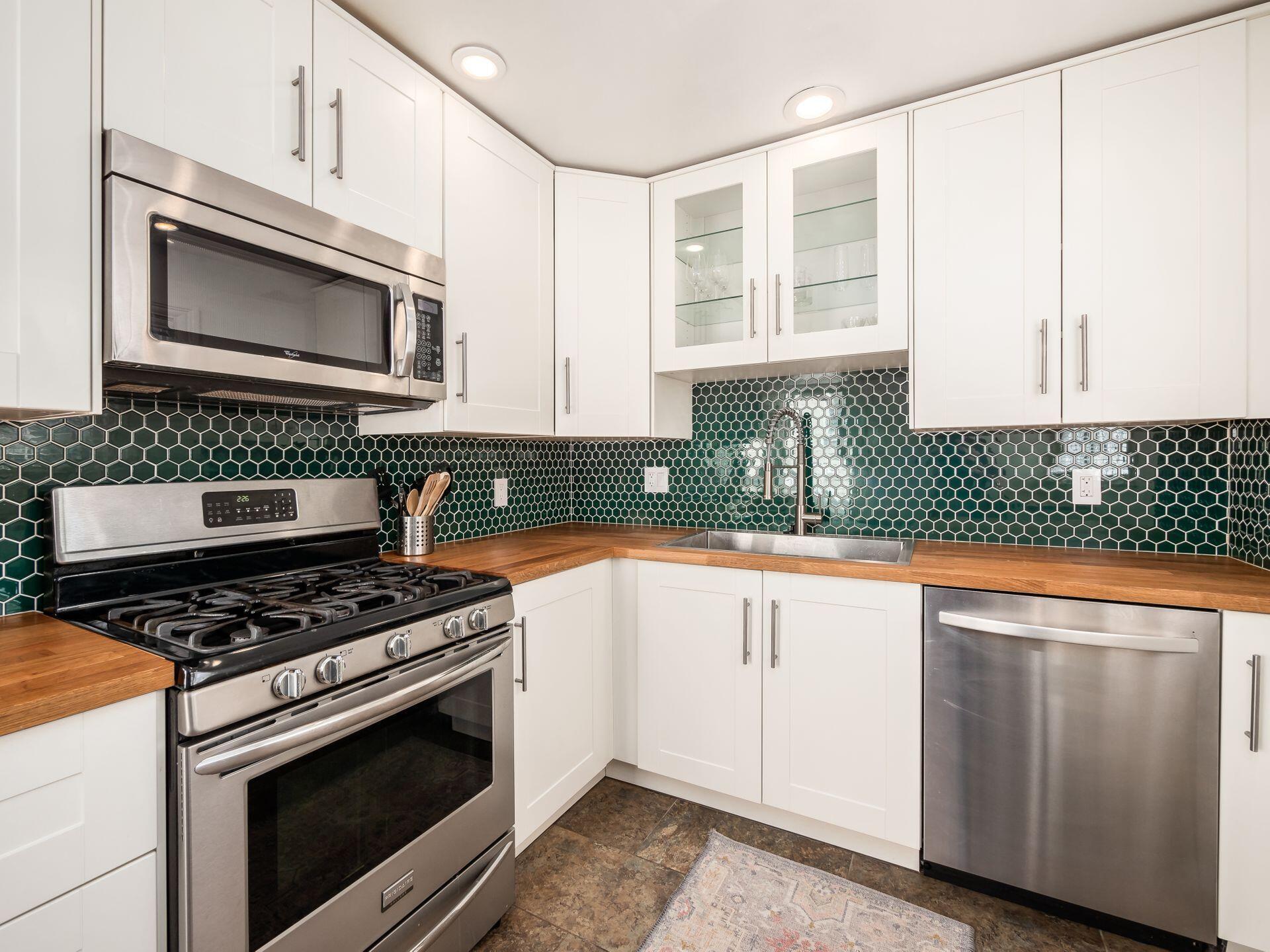 801 Timberman Road Columbus, OH 43212 - Photo 11 of 40 New white shaker cabinets, tile backsplash and butcher block countertops.
