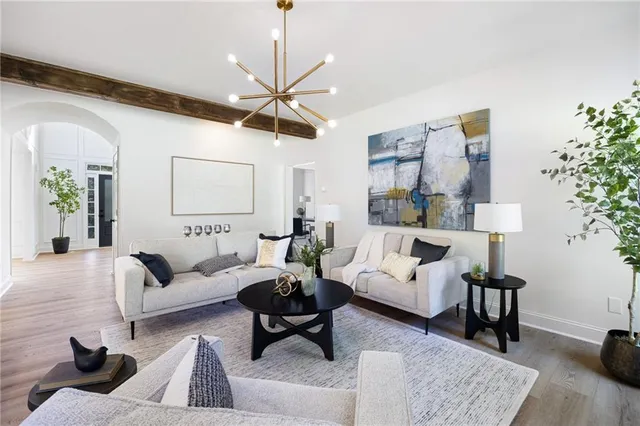 a living room with furniture or couch and a chandelier