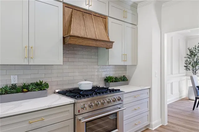 a stove top oven sitting inside of a kitchen