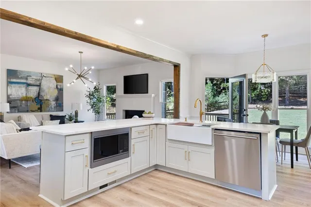 a kitchen that has a sink and a stove in it