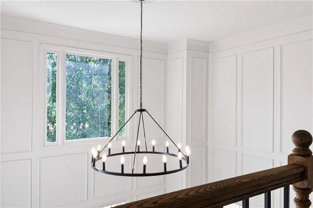 a view of a hallway with wooden floor and stairs