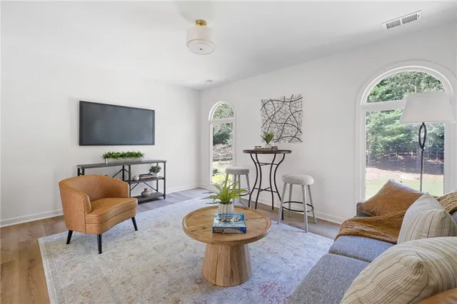 a living room with furniture and a flat screen tv