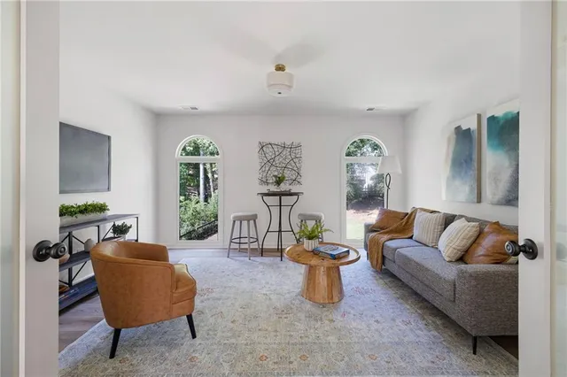 a living room with furniture and a potted plant