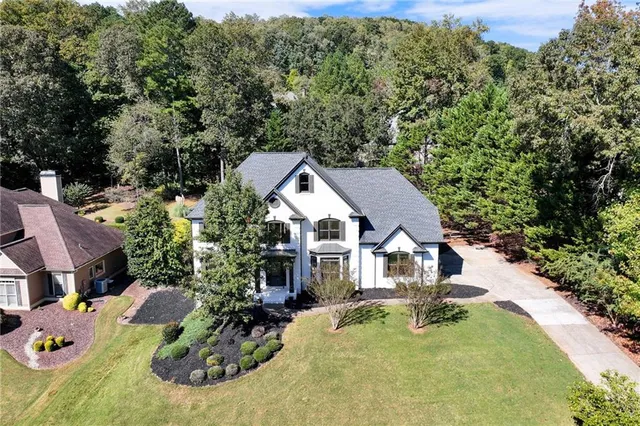 a view of a house with backyard patio and sitting area
