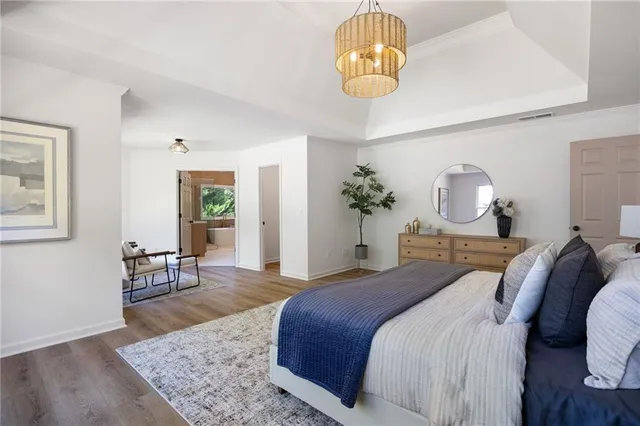 a spacious bathroom with a double vanity sink a mirror and a bathtub