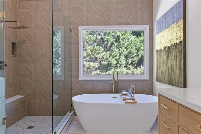 a bathroom with a double vanity sink a mirror and a bathtub