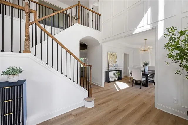 a view of entryway and hall with wooden floor