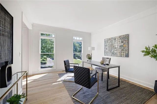 a view of a workspace with furniture and a window