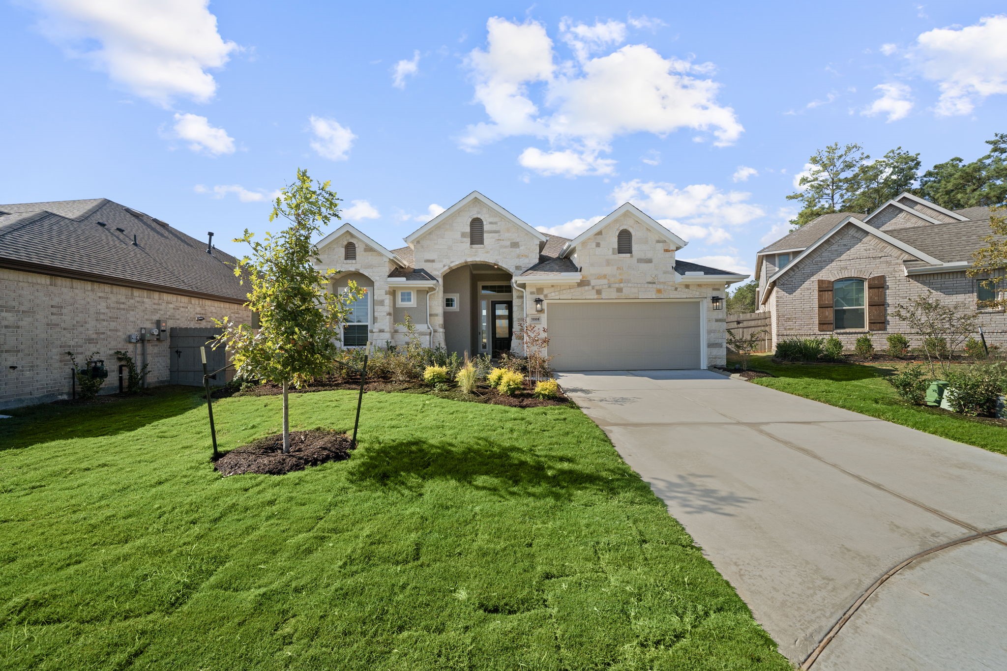 15508 Leopard Lily Lane Conroe, TX 77302 - Photo 25 of 39 a white house with a big yard and a large tree