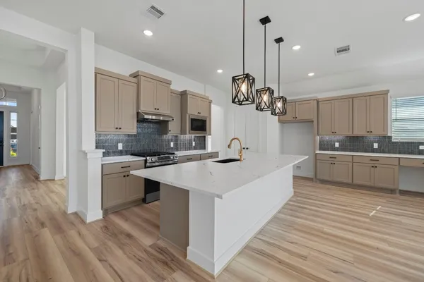 a large kitchen with a large window cabinets and stainless steel appliances