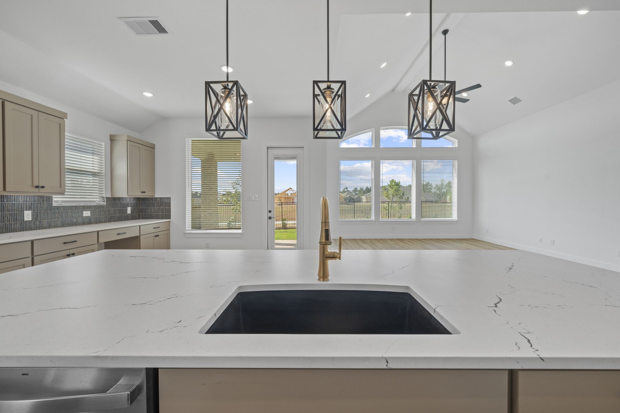 15508 Leopard Lily Lane Conroe, TX 77302 - Photo 4 of 39 a large kitchen with a large window cabinets and stainless steel appliances