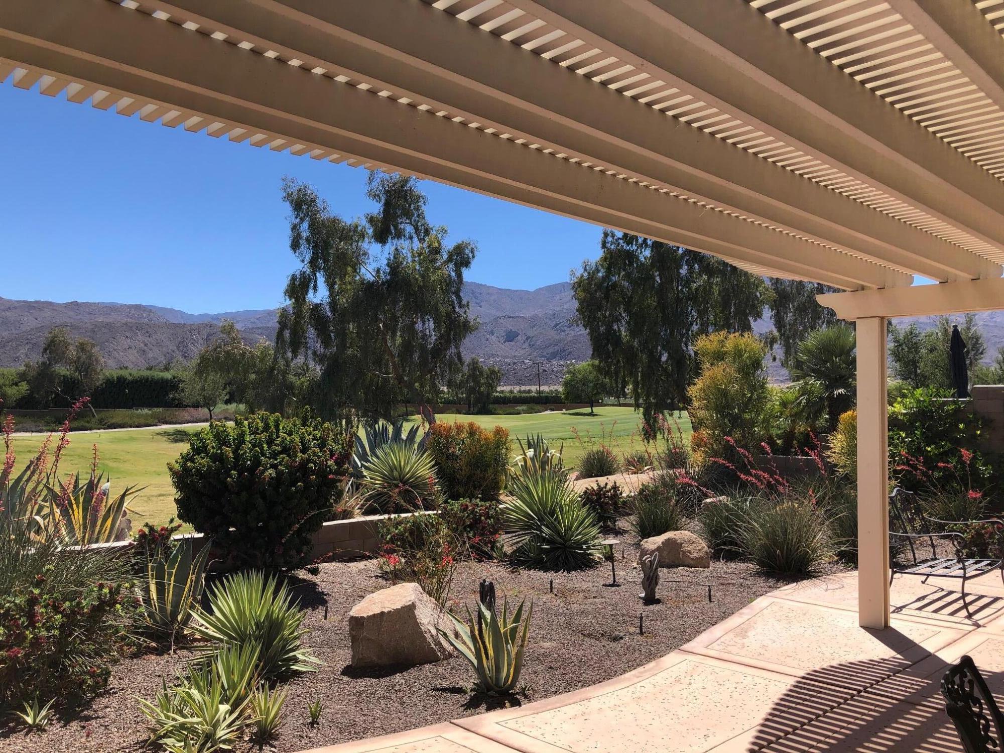 81565 Rustic Canyon Drive La Quinta, CA 92253 - Photo 2 of 12 a view of a chairs and table in patio with a lake view