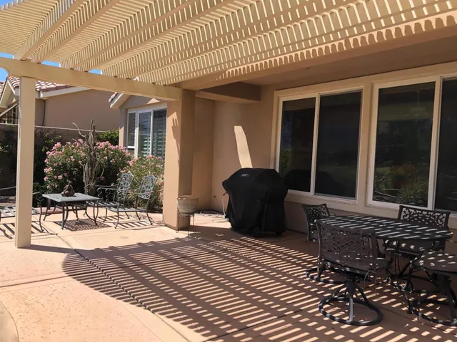 a view of a balcony with chairs and wooden floor