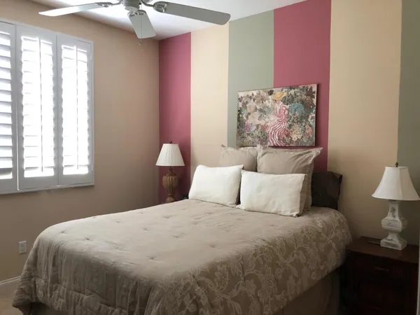 a bedroom with a bed and a lamp