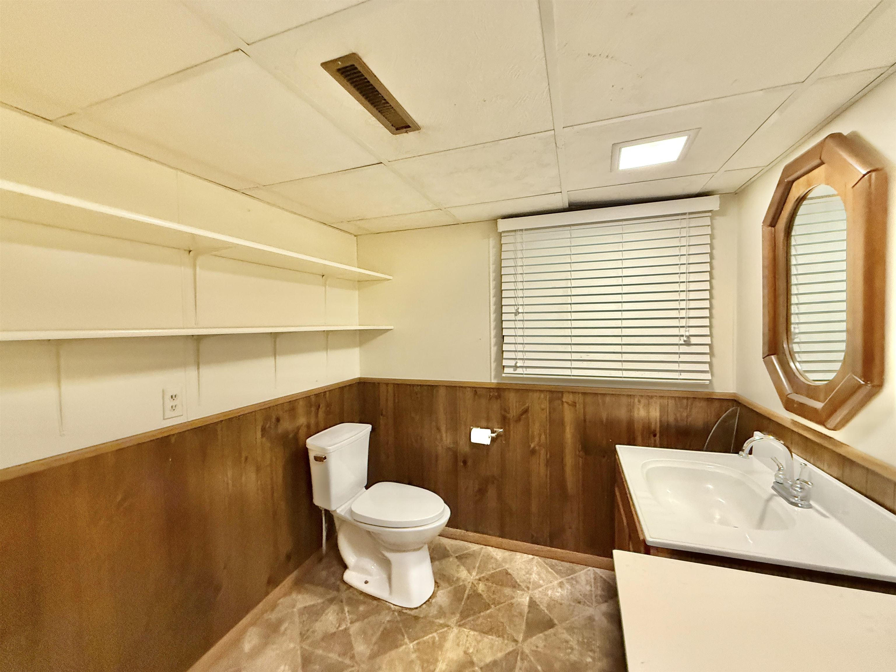 3620 Valerie Road Roscoe, IL 61073 - Photo 22 of 26 a bathroom with a toilet sink and mirror
