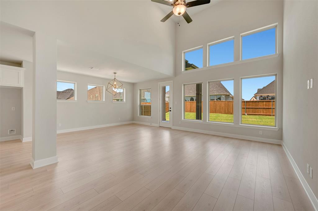 4308 Palomino Road Aubrey, TX 76227 - Photo 21 of 40 a view of an empty room with a window and wooden floor