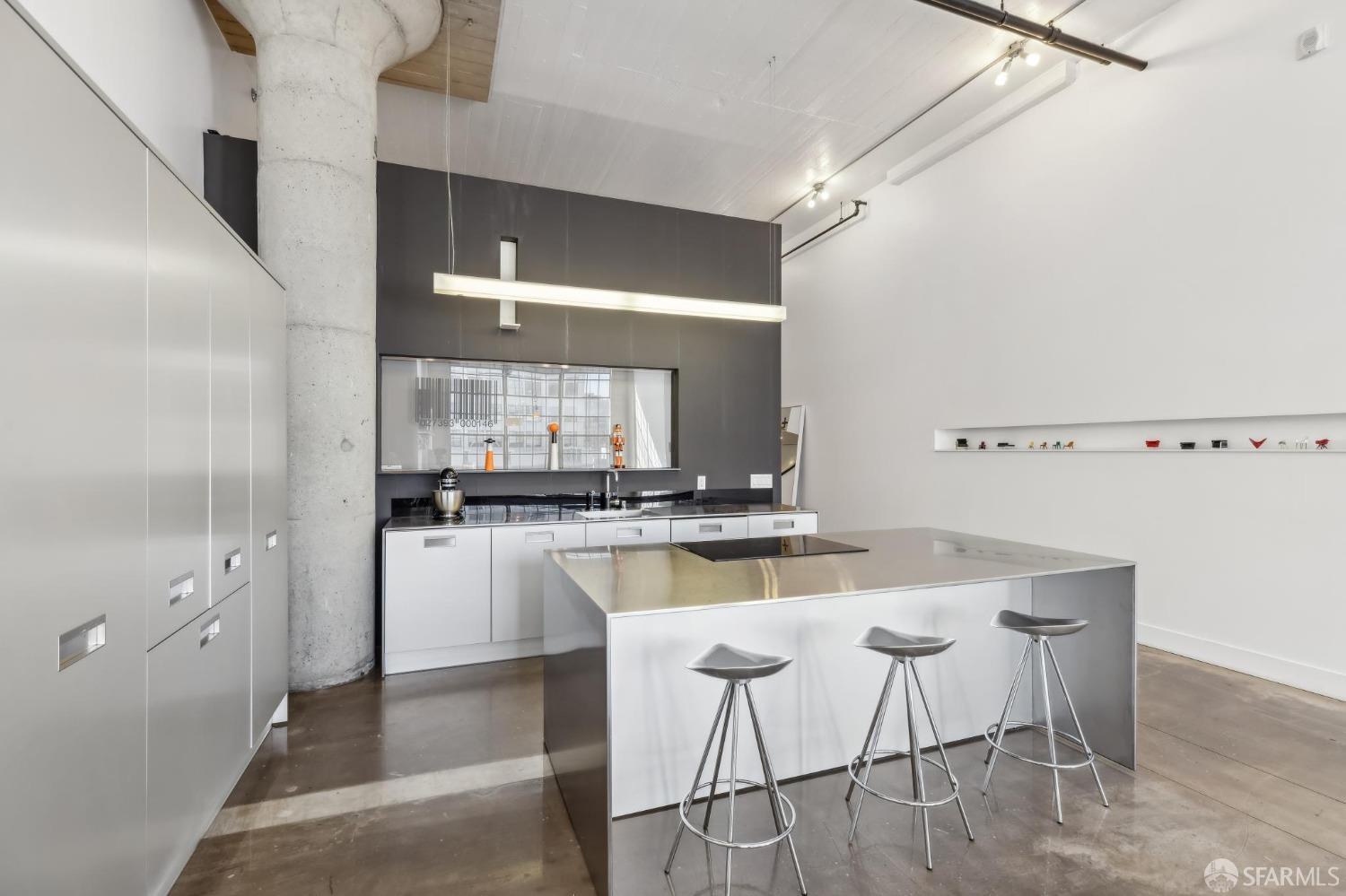 461 2nd Street, Unit 558T San Francisco, CA 94107 - Photo 16 of 37 a kitchen with a table chairs refrigerator and microwave