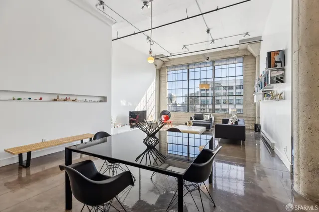 a view of a dining room with furniture and a window