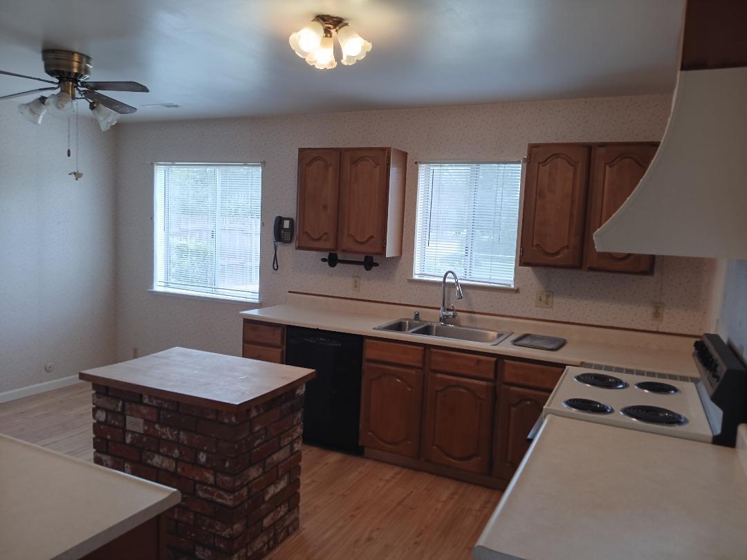 19324 Farallon Road Madera, CA 93638 - Photo 9 of 10 a kitchen with a sink stove and cabinets