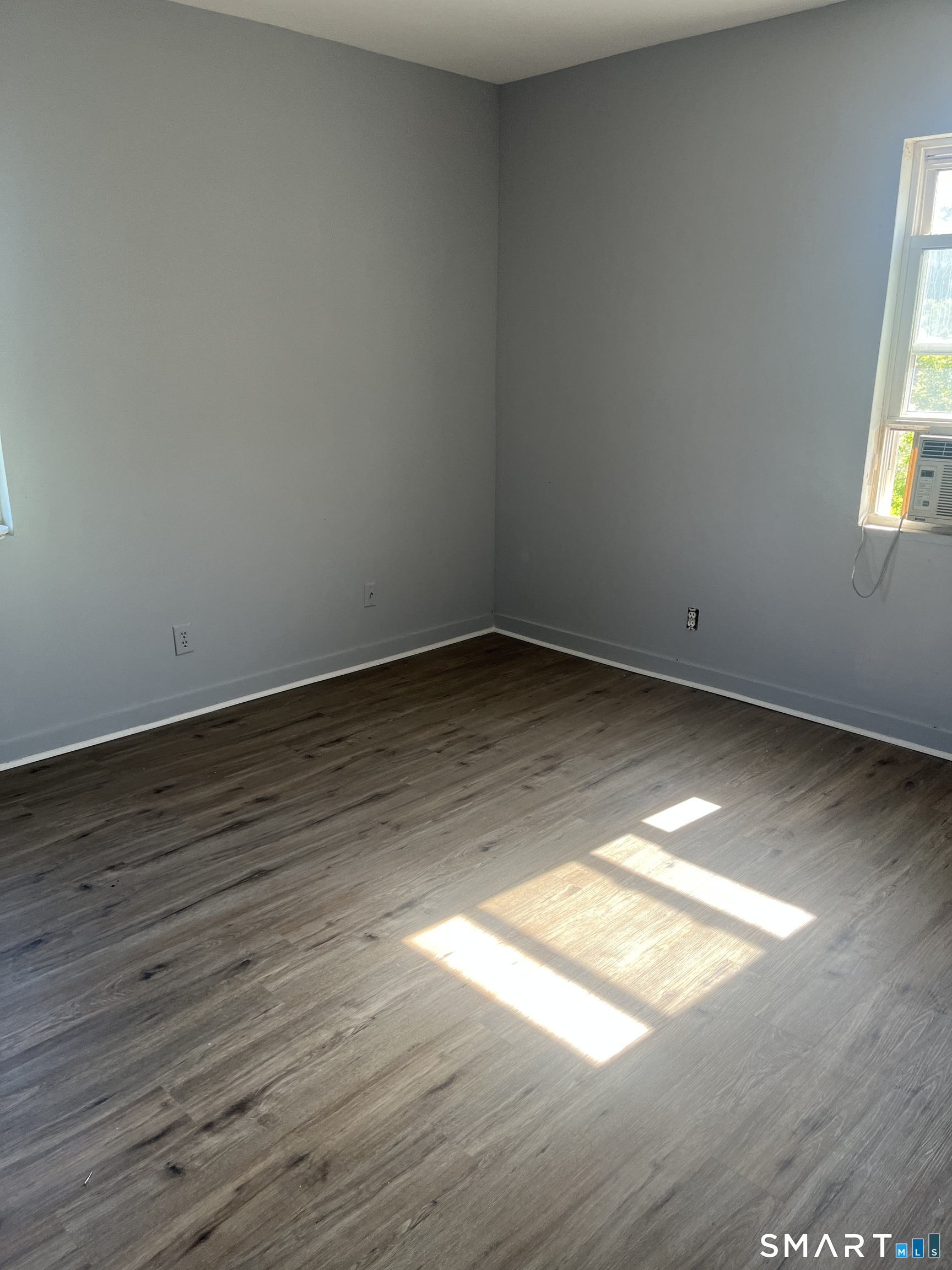 288 Cook Avenue Meriden, CT 06451 - Photo 8 of 11 a view of empty room with wooden floor and fan