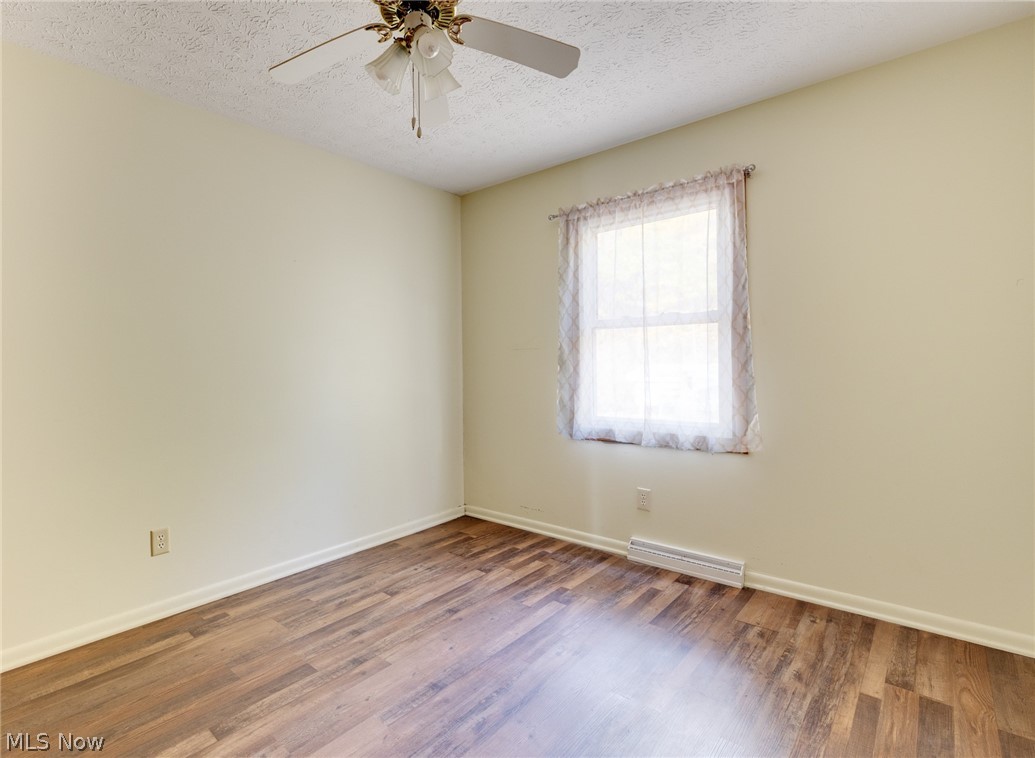 9416 Kieffer Road Mantua, OH 44255 - Photo 22 of 29 Bedroom featuring a textured ceiling and wood style floors