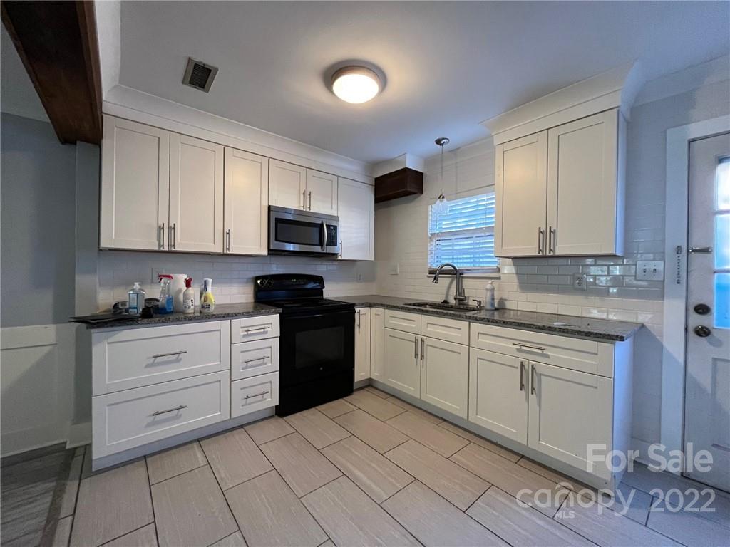 6300 Old Pineville Road Charlotte, NC 28217 - Photo 3 of 4 a kitchen with cabinets appliances and a sink