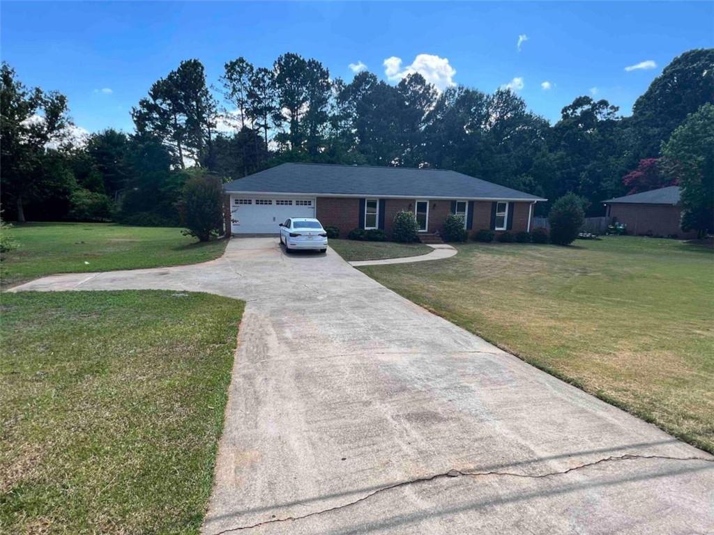 1051 Jimmy Daniel Road Watkinsville, GA 30677 - Photo 1 of 1 a front view of a house with garden