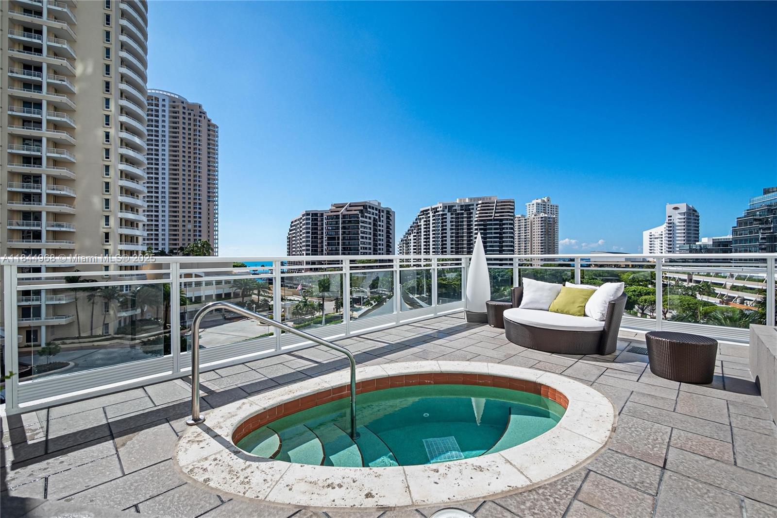 900 Brickell Key Boulevard, Unit 2005 Miami, FL 33131 - Photo 17 of 19 a view of roof deck with outdoor seating and city view