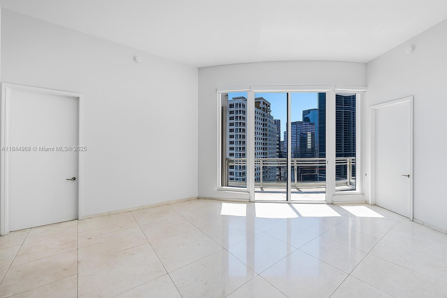 900 Brickell Key Boulevard, Unit 2005 Miami, FL 33131 - Photo 10 of 19 a view of an empty room with a window