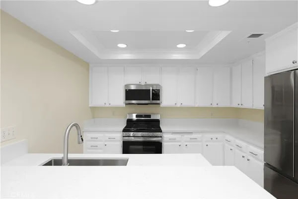 a kitchen with a refrigerator and a sink