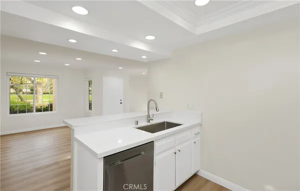 a kitchen with a sink vanity and a window