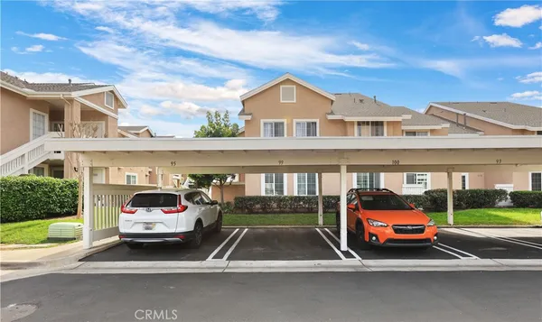 a car parked in front of a house with a yard