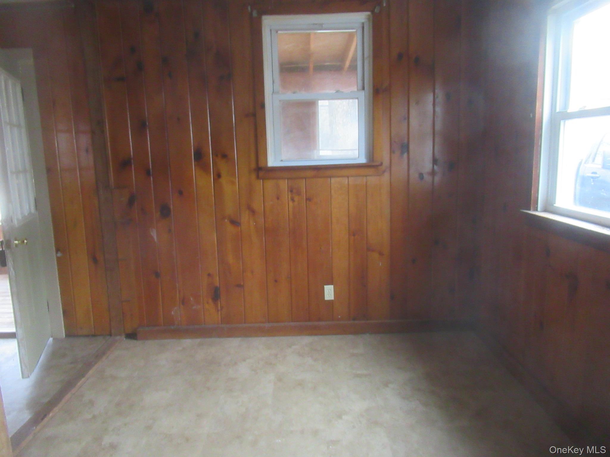 162 Osborne Hill Road Fishkill, NY 12524 - Photo 11 of 11 Empty room featuring wooden walls and tile patterned floors