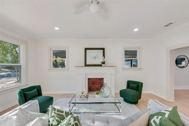 a living room with furniture and a potted plant