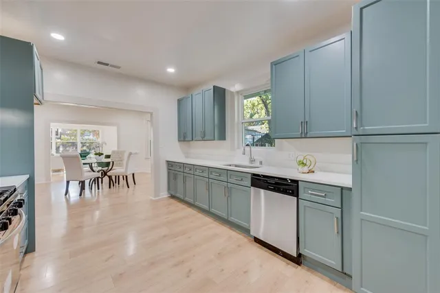 a kitchen with a sink cabinets and window