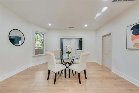 a dining room with furniture and a window