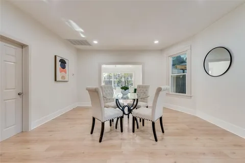 a dining room with furniture and wooden floor