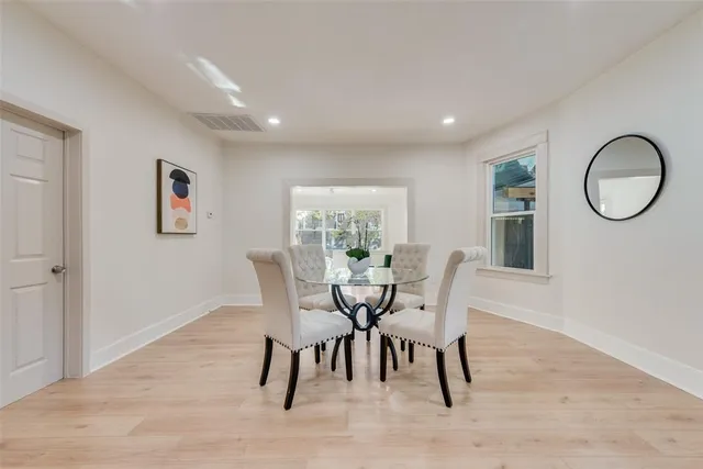 a dining room with furniture and wooden floor