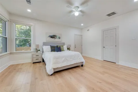 a bedroom with a large bed and a window