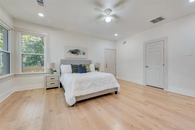 a bedroom with a large bed and a window