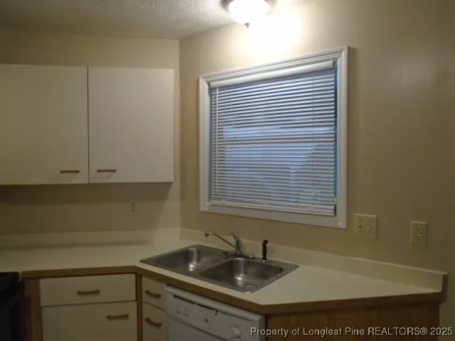 a kitchen with a stove and white cabinets