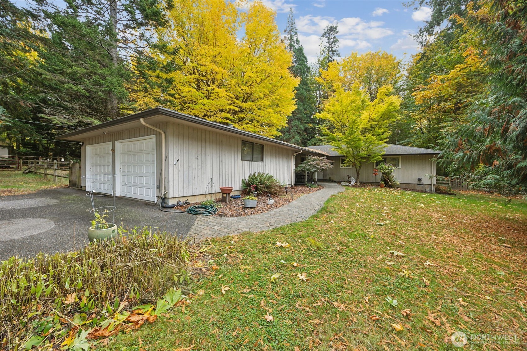a view of a house with backyard and sitting area