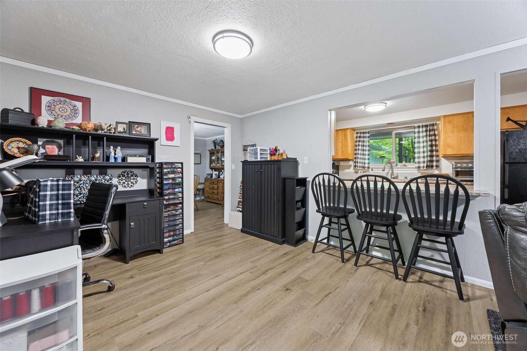 5700 Cooper Point Road Northwest Olympia, WA 98502 - Photo 14 of 31 a view of a dining room with furniture and wooden floor