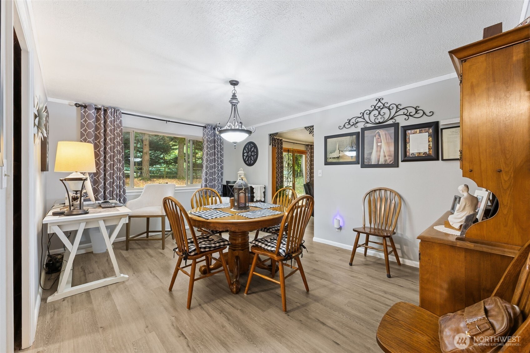 5700 Cooper Point Road Northwest Olympia, WA 98502 - Photo 17 of 31 a view of a dining room with furniture window and wooden floor