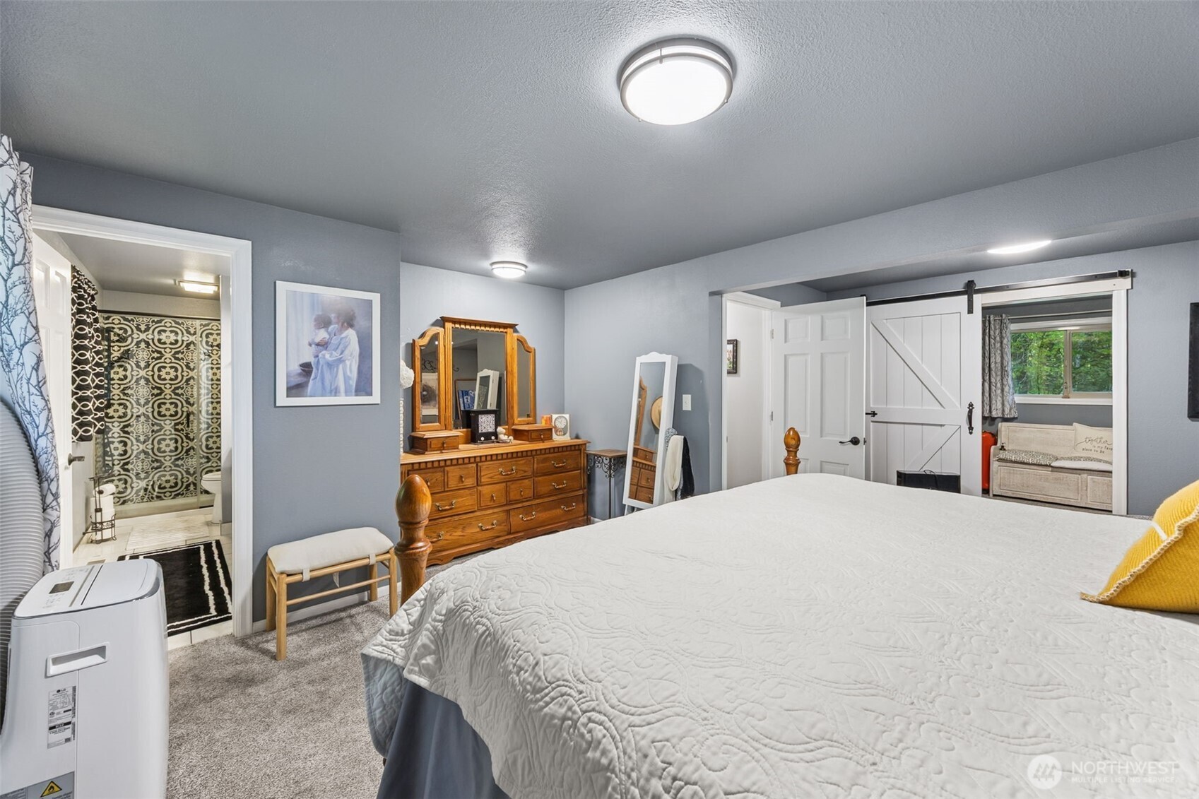 5700 Cooper Point Road Northwest Olympia, WA 98502 - Photo 20 of 31 a bedroom with a large bed and a closet