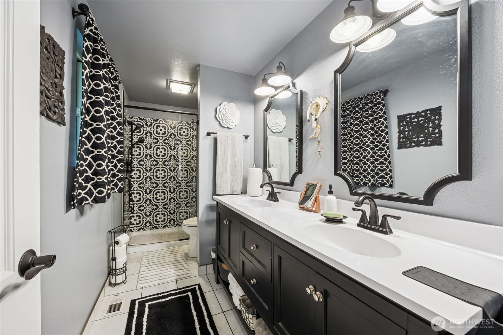5700 Cooper Point Road Northwest Olympia, WA 98502 - Photo 21 of 31 a bathroom with a double vanity sink mirror and double