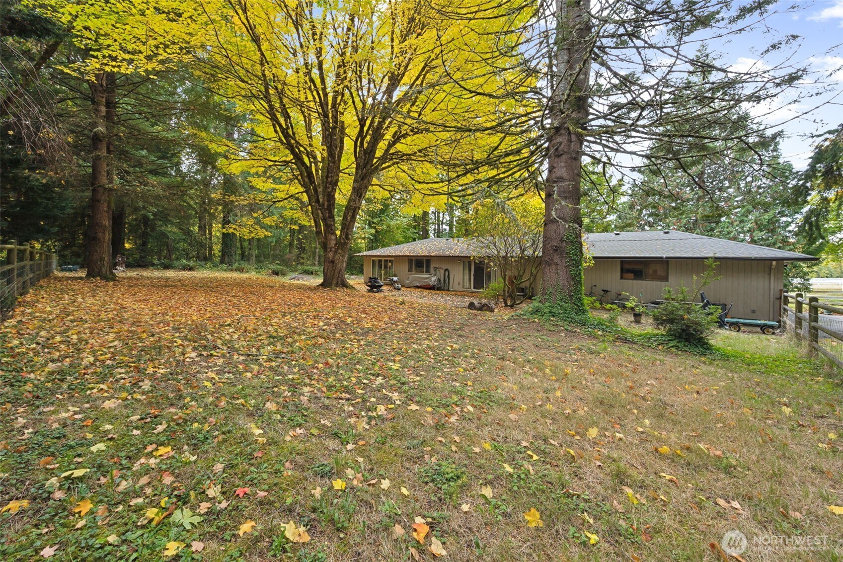 5700 Cooper Point Road Northwest Olympia, WA 98502 - Photo 5 of 31 a backyard of a house with table and chairs